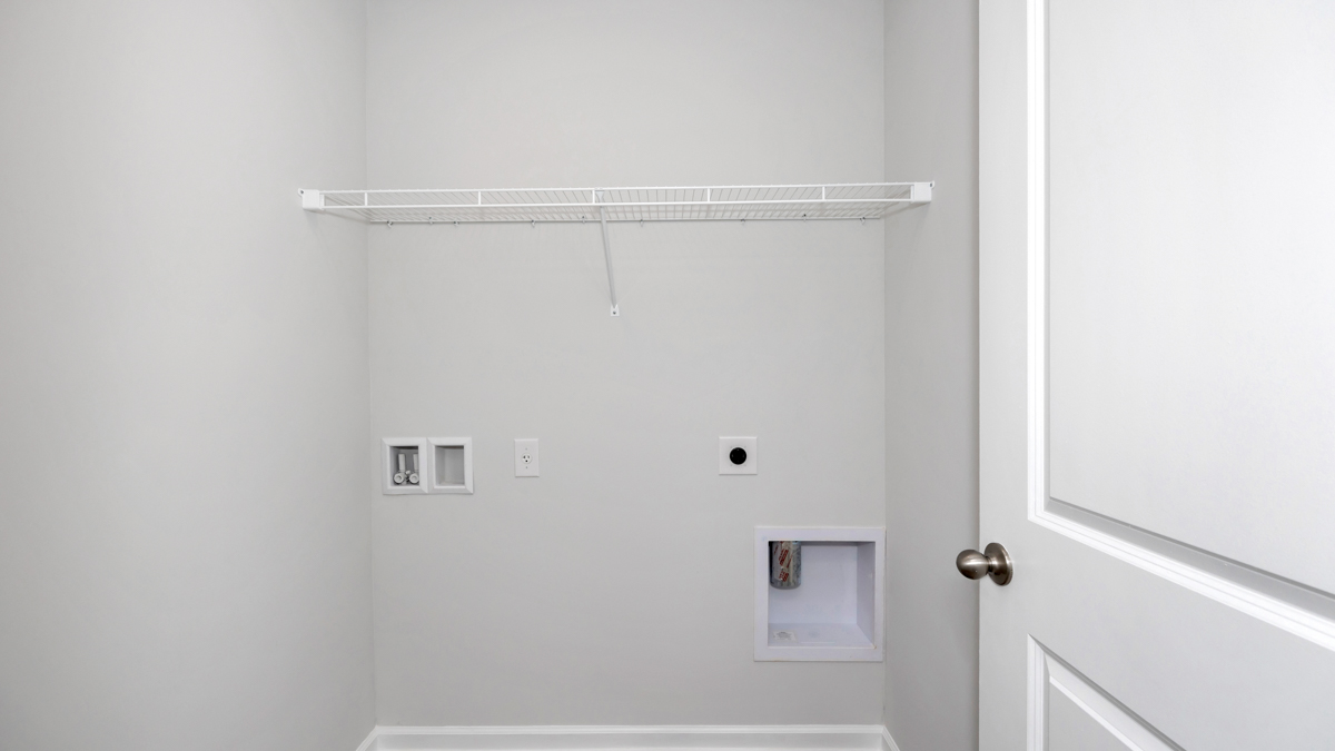 Laundry room with wire shelf and washer dryer hook up