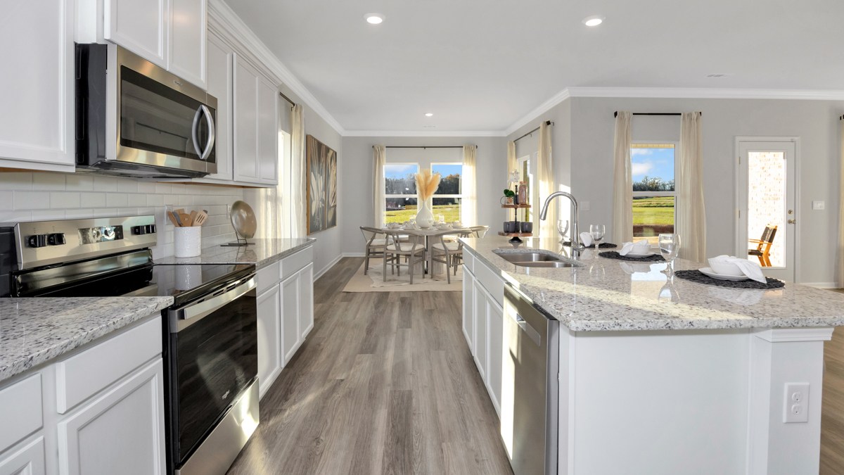 Kitchen island with painted cabinets and stainless steel appliances