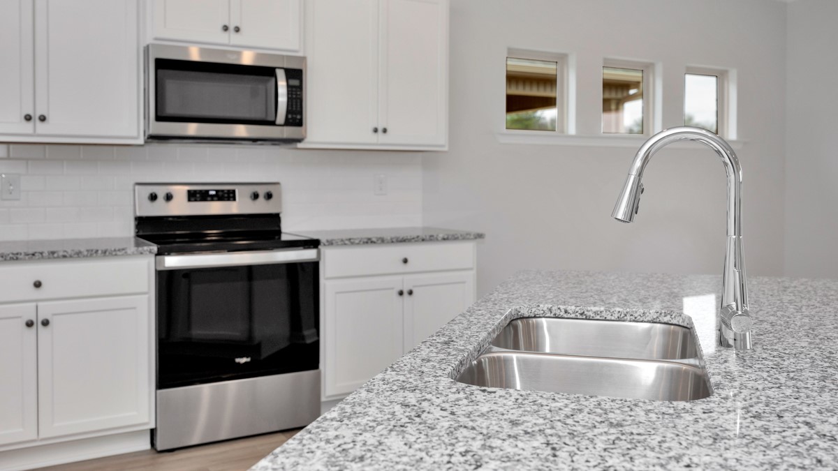 Kitchen sink with granite surround and stainless steel appliances