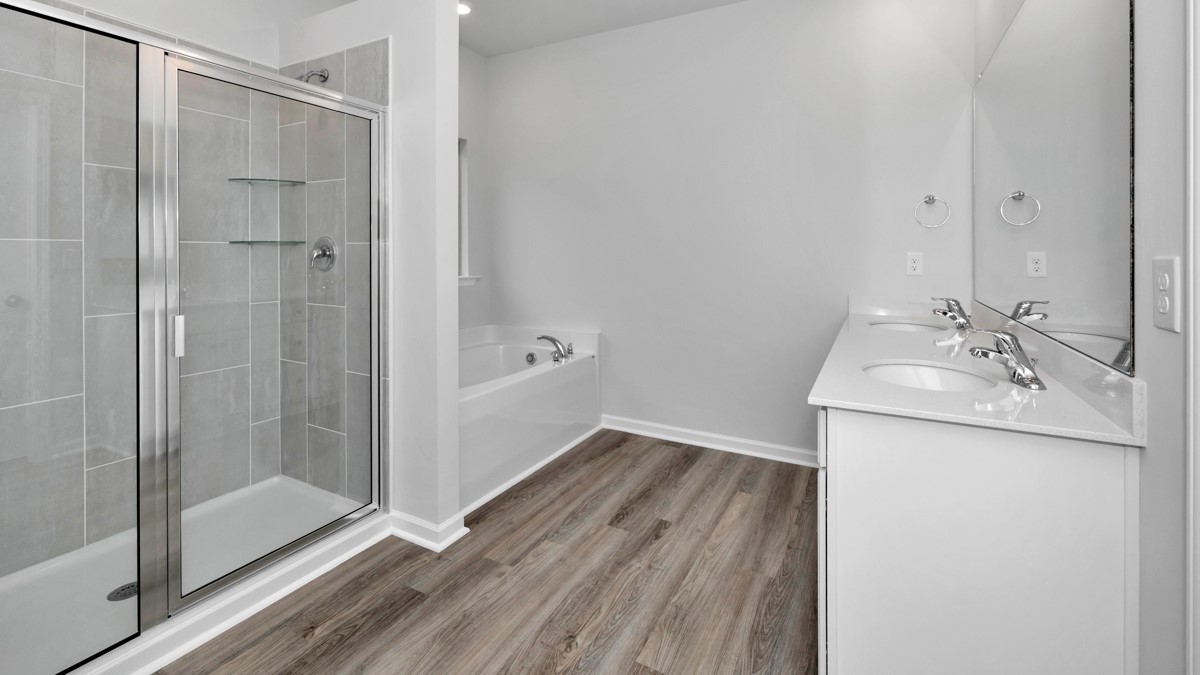 Primary bath with painted cabinets and quartz countertops