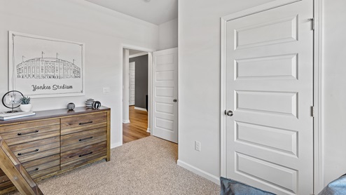 Secondary bedroom with carpet and window