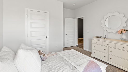 Secondary bedroom with carpet and window