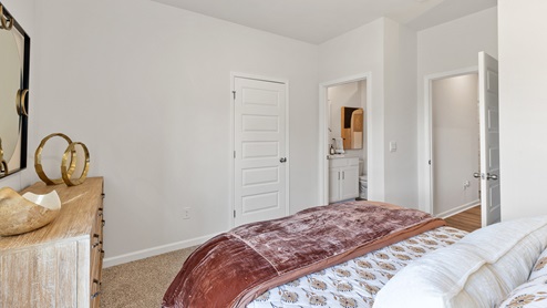 Secondary bedroom with carpet and window