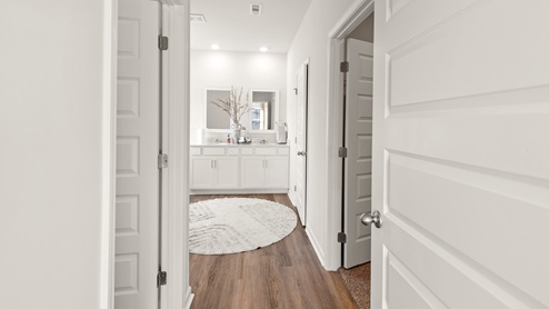 Primary bath with painted cabinets and quartz countertops