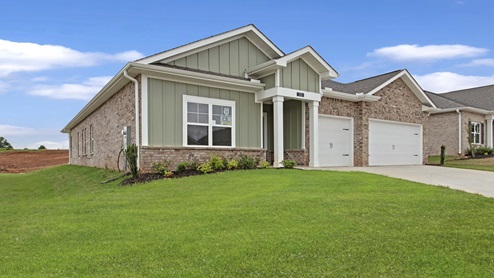 single story brick and hardi home with three car garage