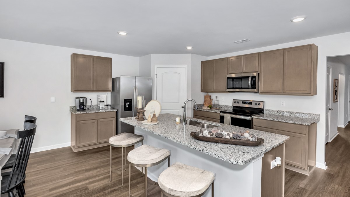 Kitchen island with stained cabinets and stainless steel appliances