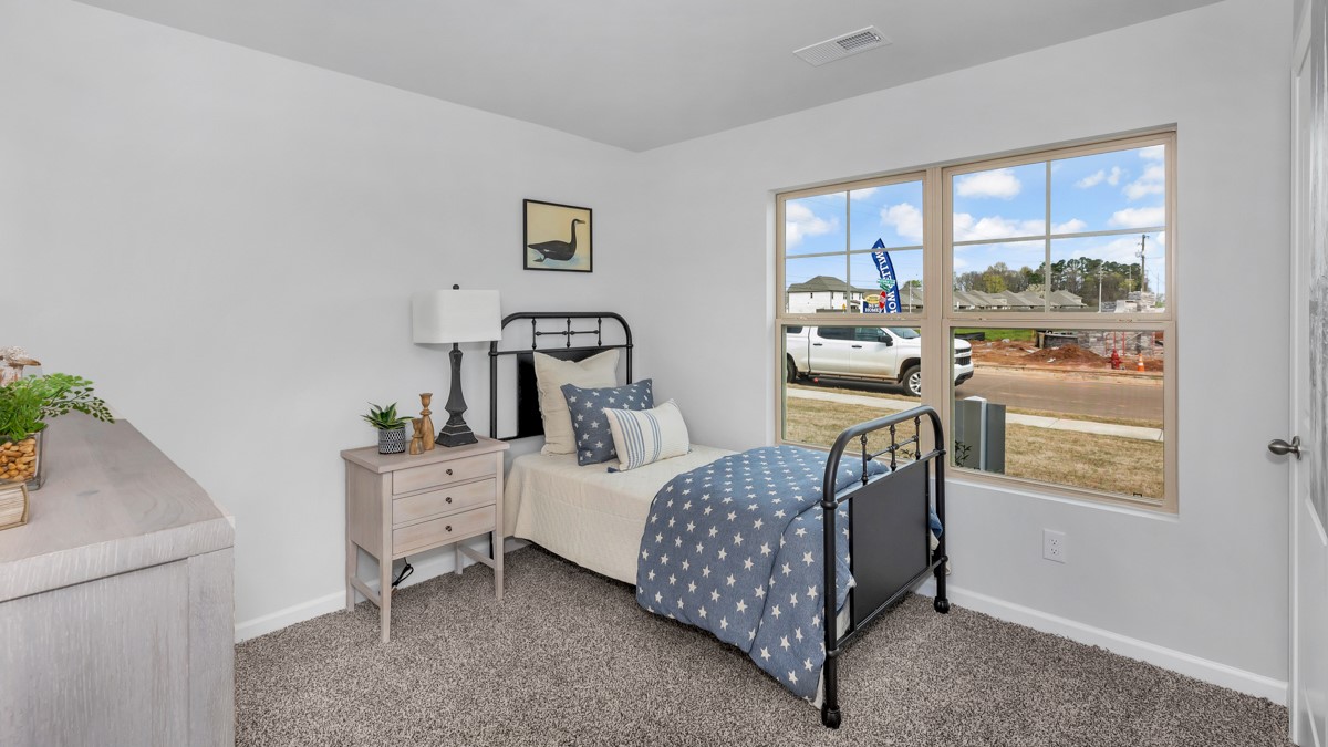 Secondary bedroom with LVP flooring and window
