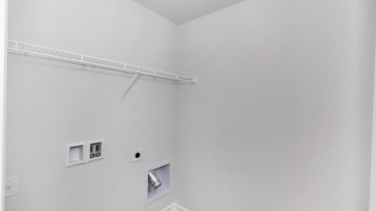 Laundry room with wire shelf and washer dryer hook up
