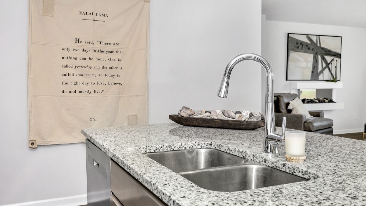 Kitchen sink with granite surround and stainless steel appliances