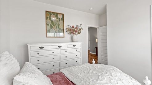 Secondary bedroom with carpet and window