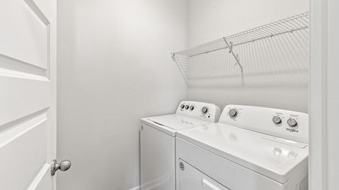 Laundry room with wire shelf and washer dryer hook up