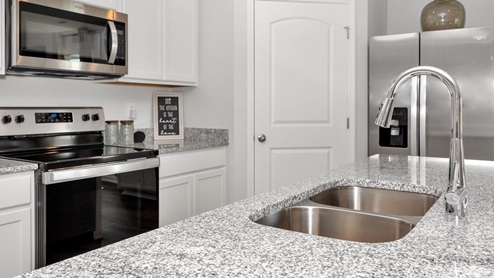 Kitchen sink with granite surround and stainless steel