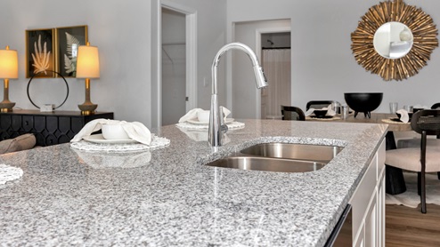 Kitchen sink with granite surround and stainless steel