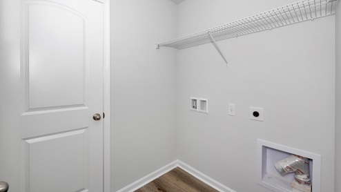 Laundry room with wire shelf and washer dryer hook up