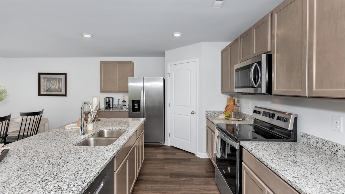 Kitchen island with stained cabinets and stainless steel appliances