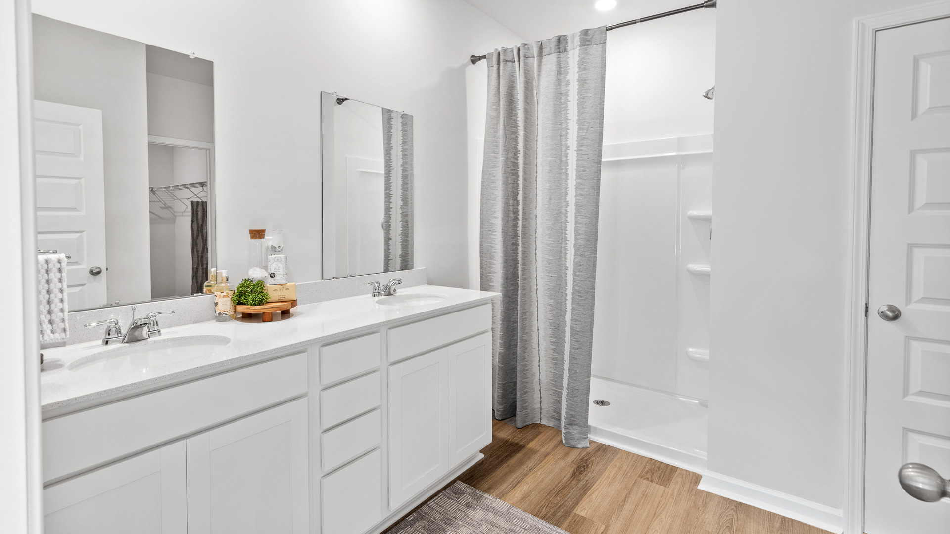 Primary bath with painted cabinets and quartz countertops