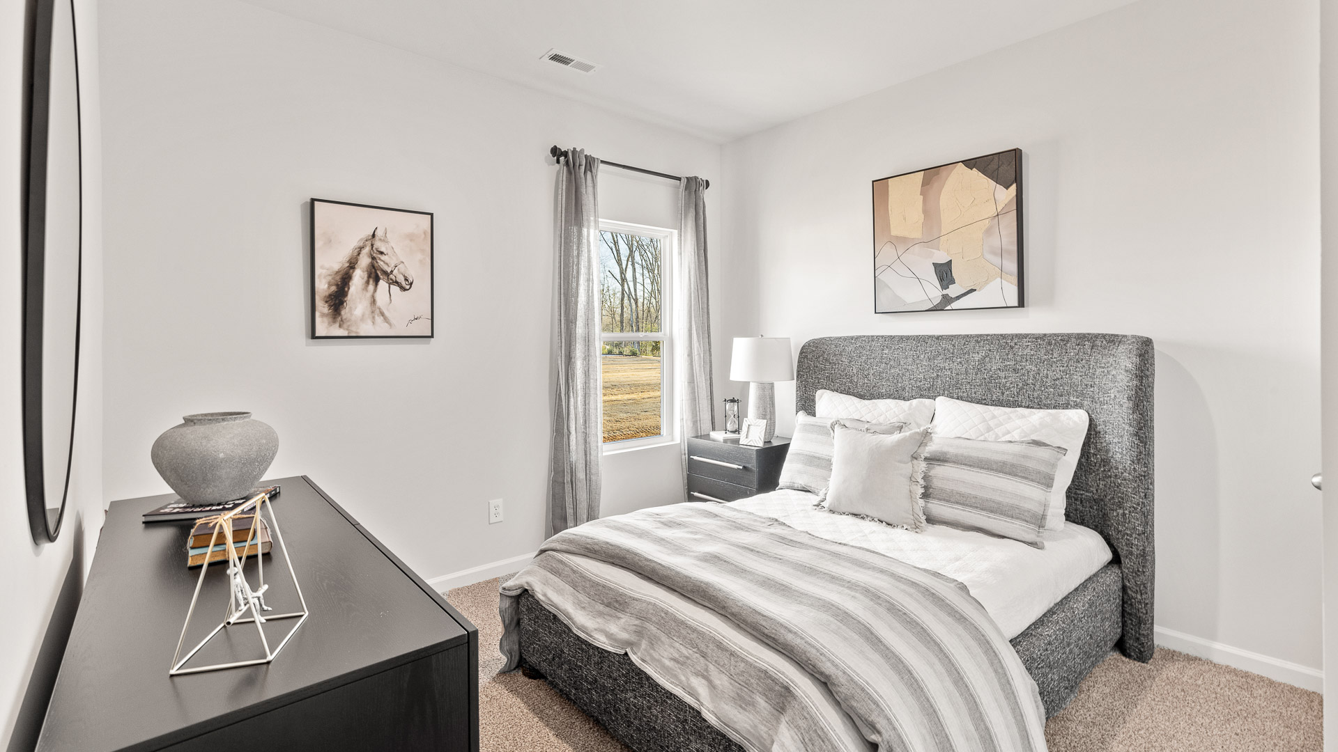 Secondary bedroom with carpet and window