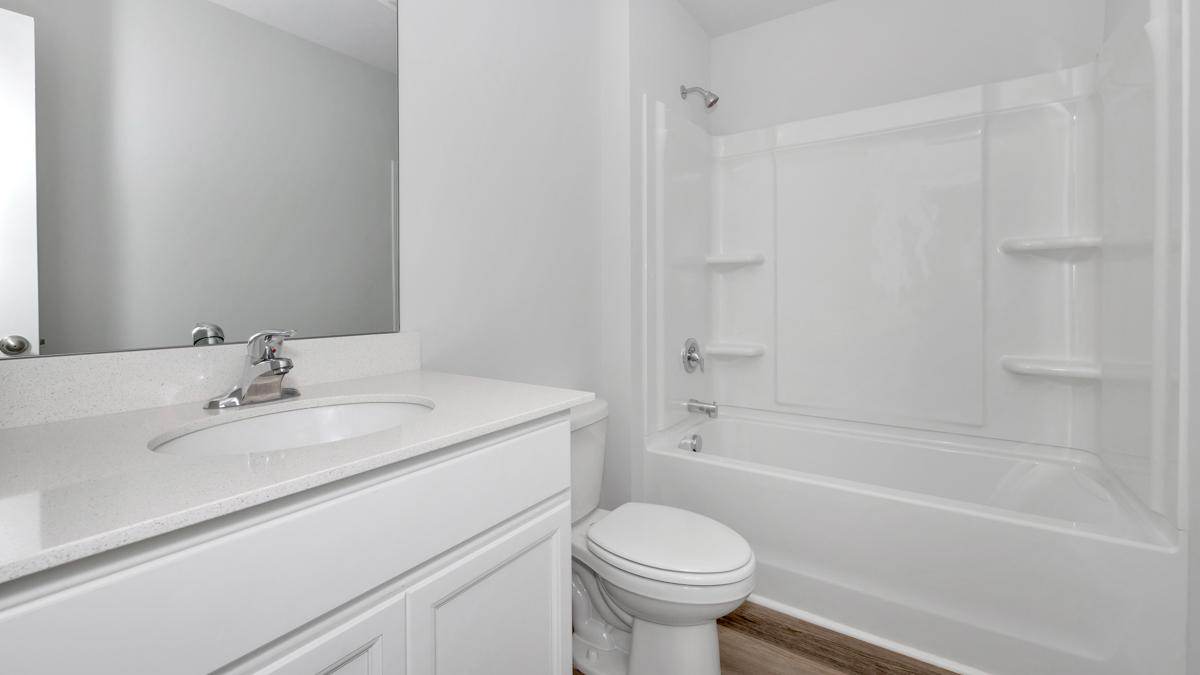 Secondary bathroom with painted cabinets and quartz countertops