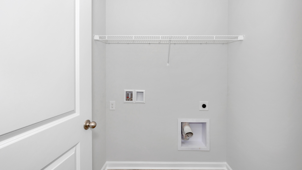 Laundry room with wire shelf and washer dryer hook up