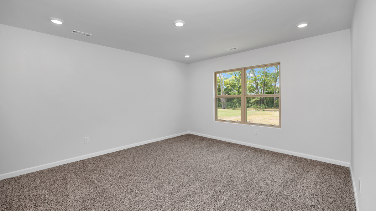 Primary bedroom with carpet