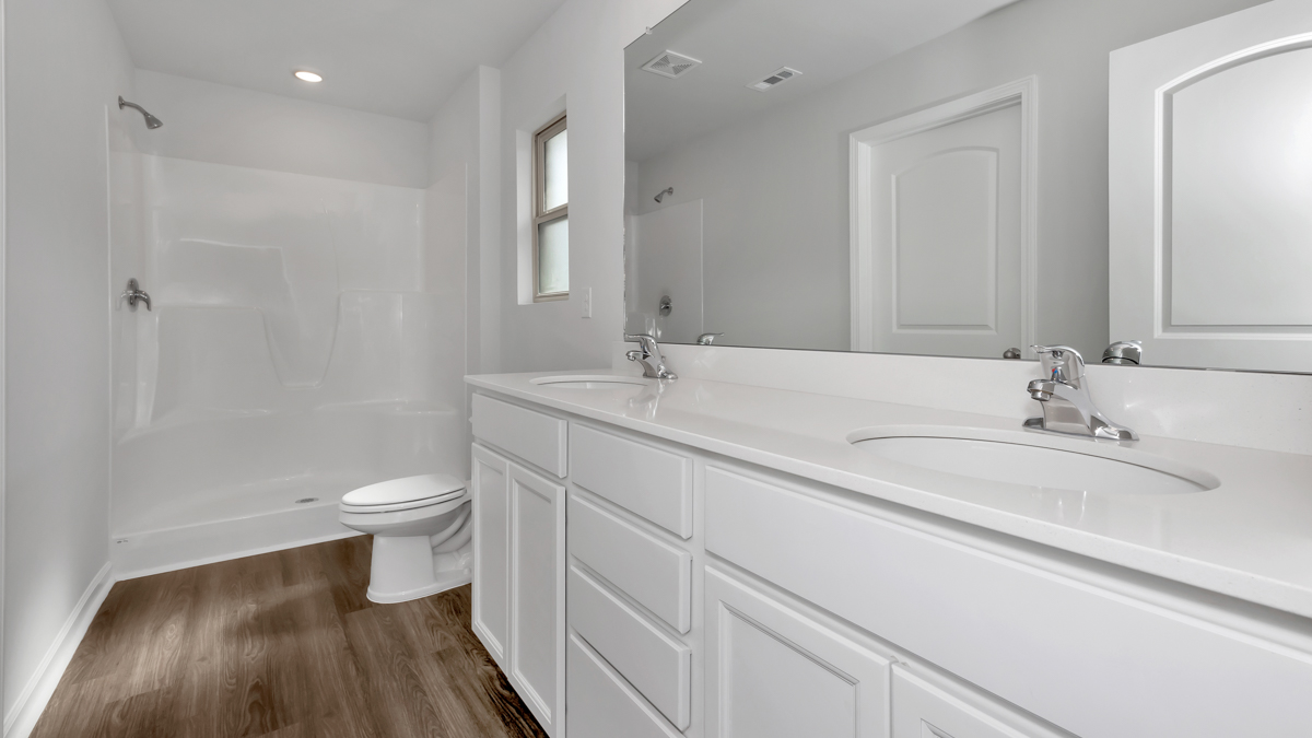Primary bath with painted cabinets and quartz countertops