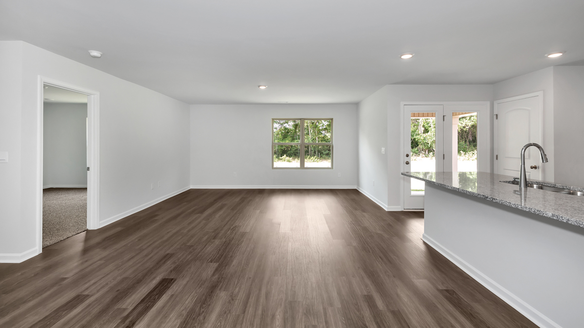 Kitchen island with painted cabinets and stainless steel appliances