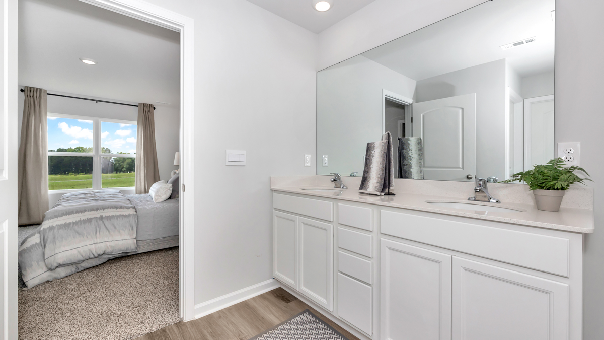 Primary bath with painted cabinets and quartz countertops