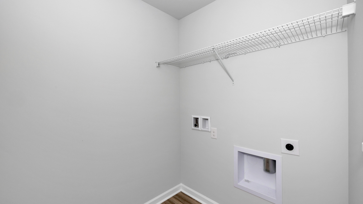 Laundry room with wire shelf and washer dryer hook up