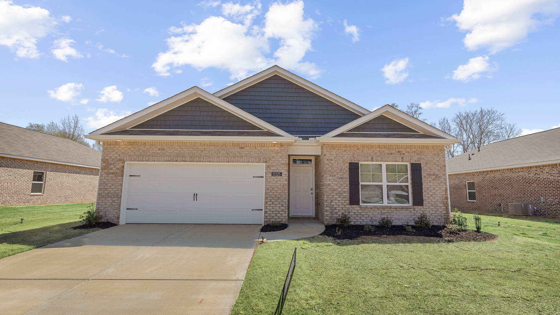 Single story home with hardi and brick and two car garage