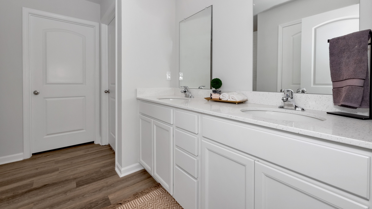 Primary bath with painted cabinets and quartz countertops
