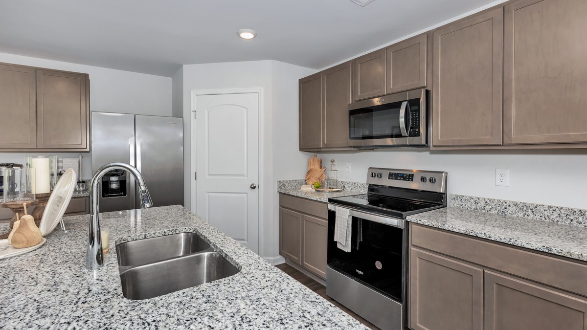 Kitchen sink with granite surround and stainless steel appliances