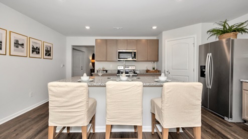 Kitchen island with stained cabinets and stainless steel appliances