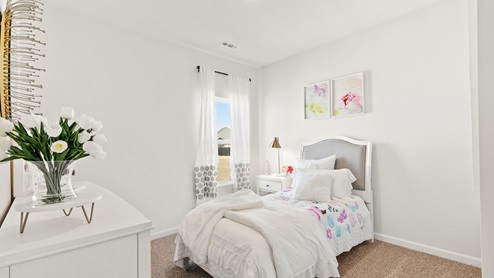Secondary bedroom with carpet and window
