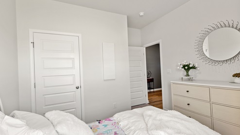 Secondary bedroom with carpet and window