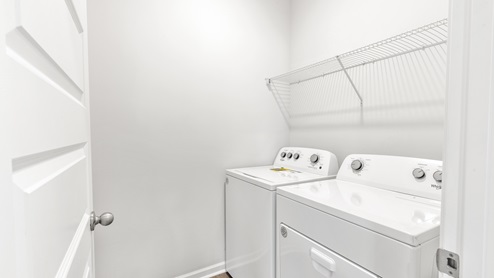 Laundry room with wire shelf and washer dryer hook up