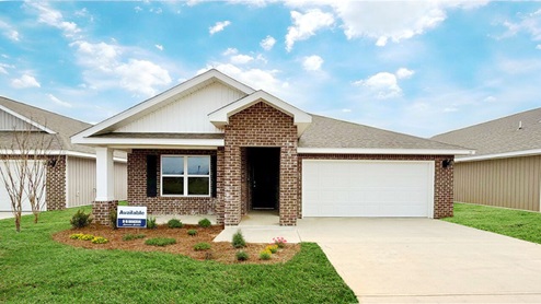 Exterior elevation of new red brick home with white trim and a two-car garage