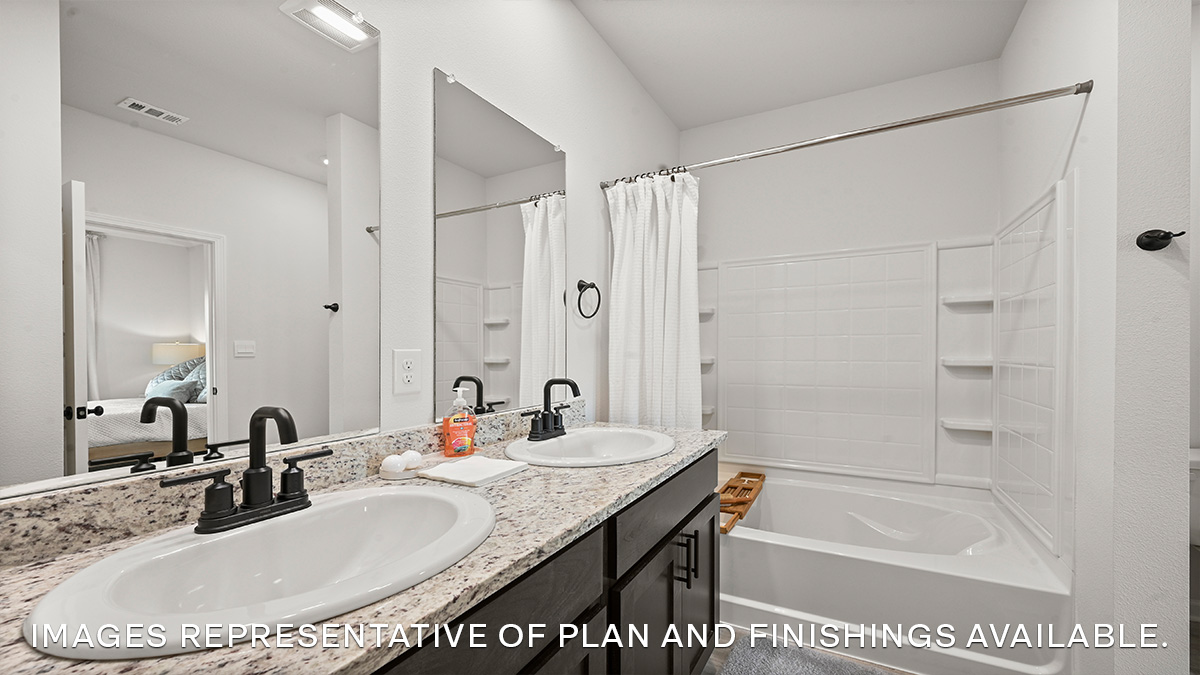 White dual vanities with garden tub in primary bathroom