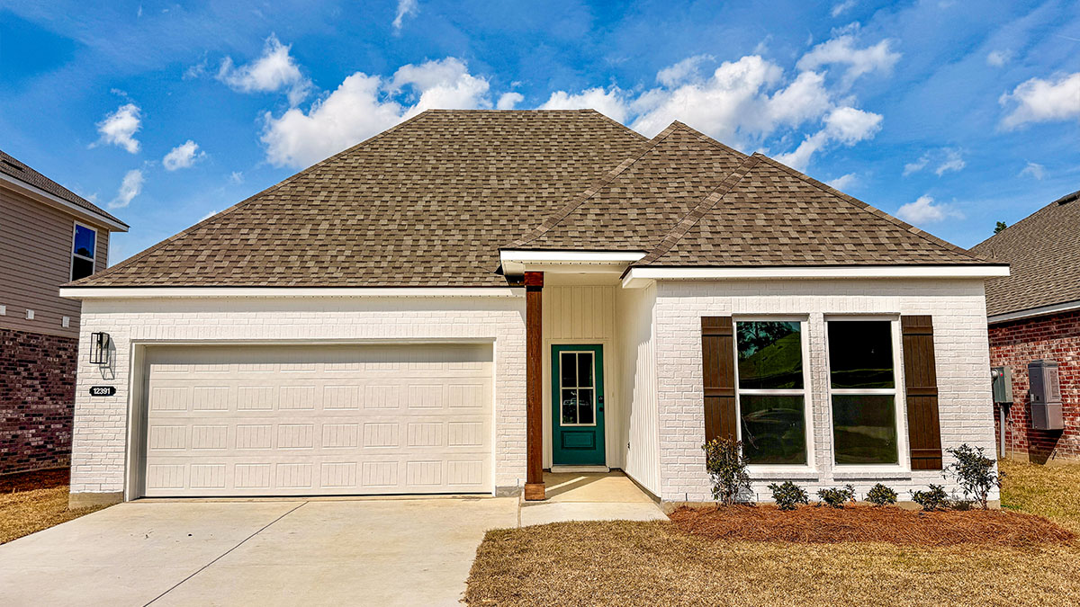 single-story home with white brick and blue front door and black shutters with two-car garage