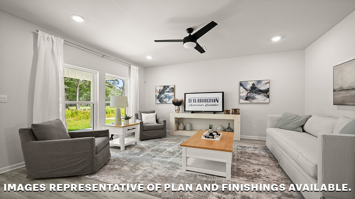open-concept living room with dual windows showcasing the backyard