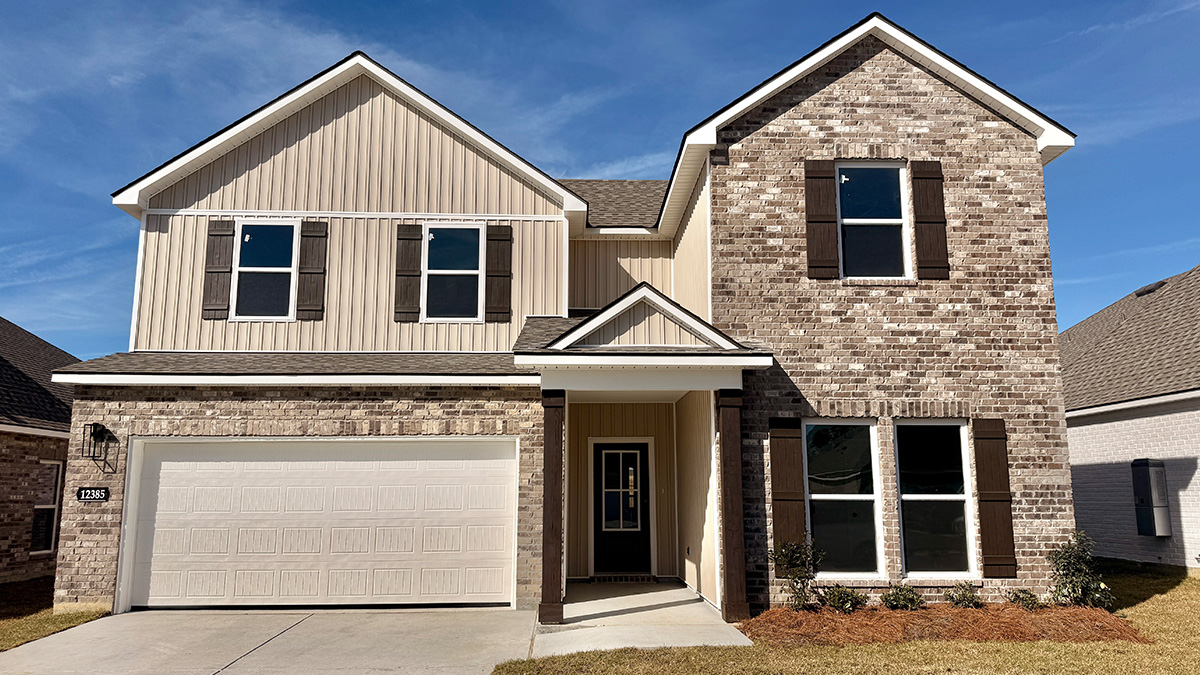 double-story home with brown brick and tan vinyl siding with brown front door and shutters with two-car garage