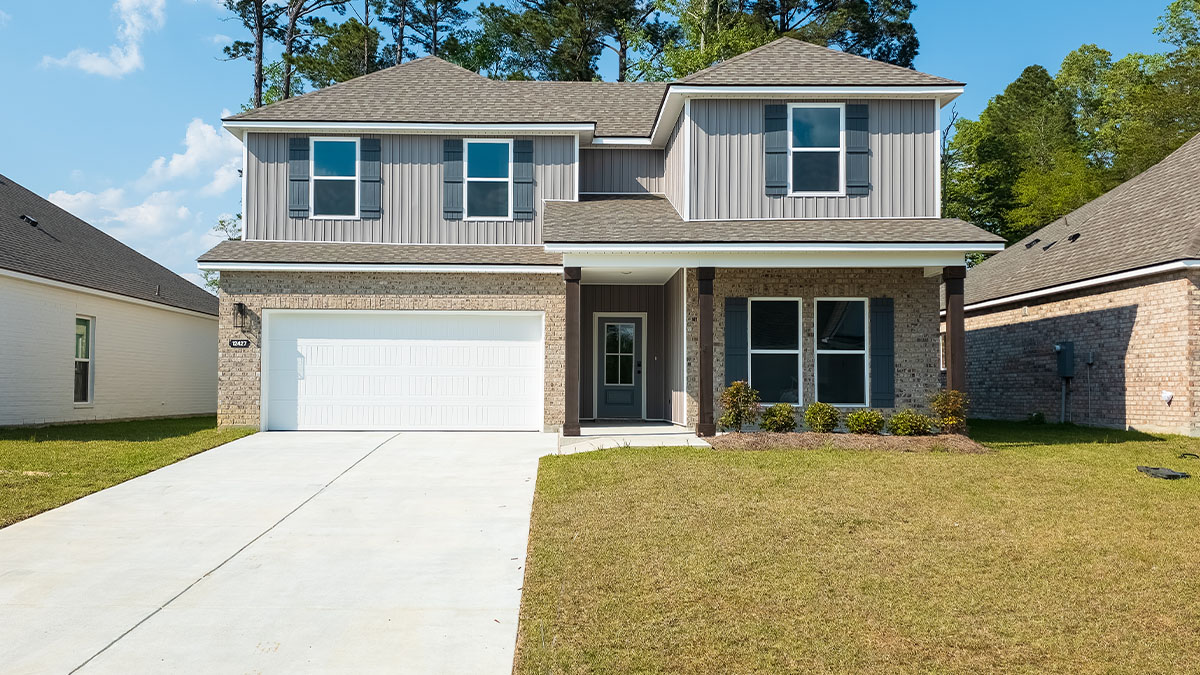 double-story home with tan brick and light gray vinyl siding with gray front door and shutters with porch and two-car garage