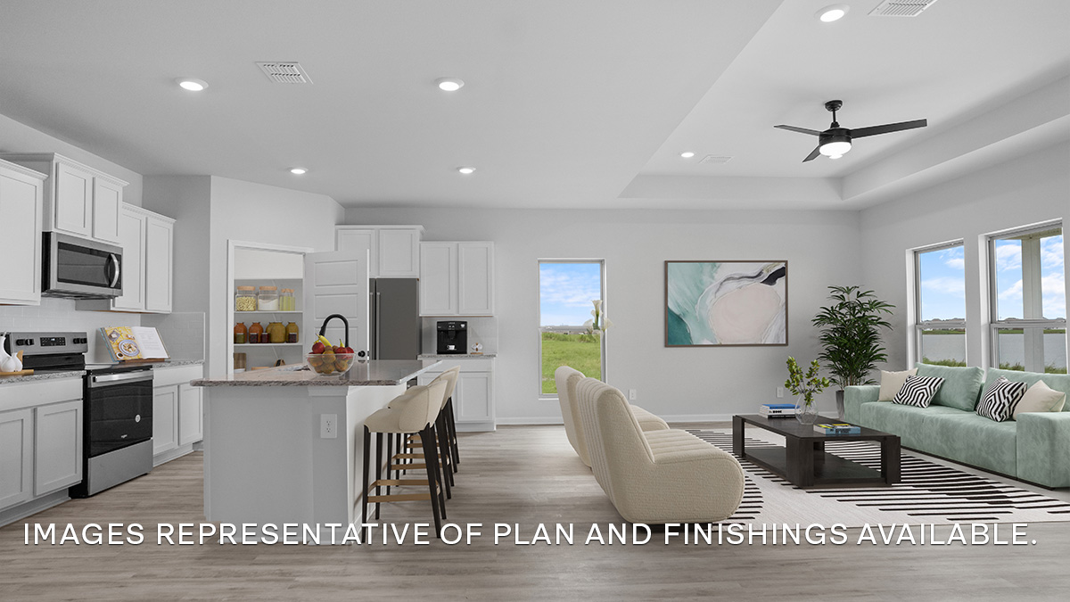 Open-concept kitchen with island and stainless steel appliances along with living room