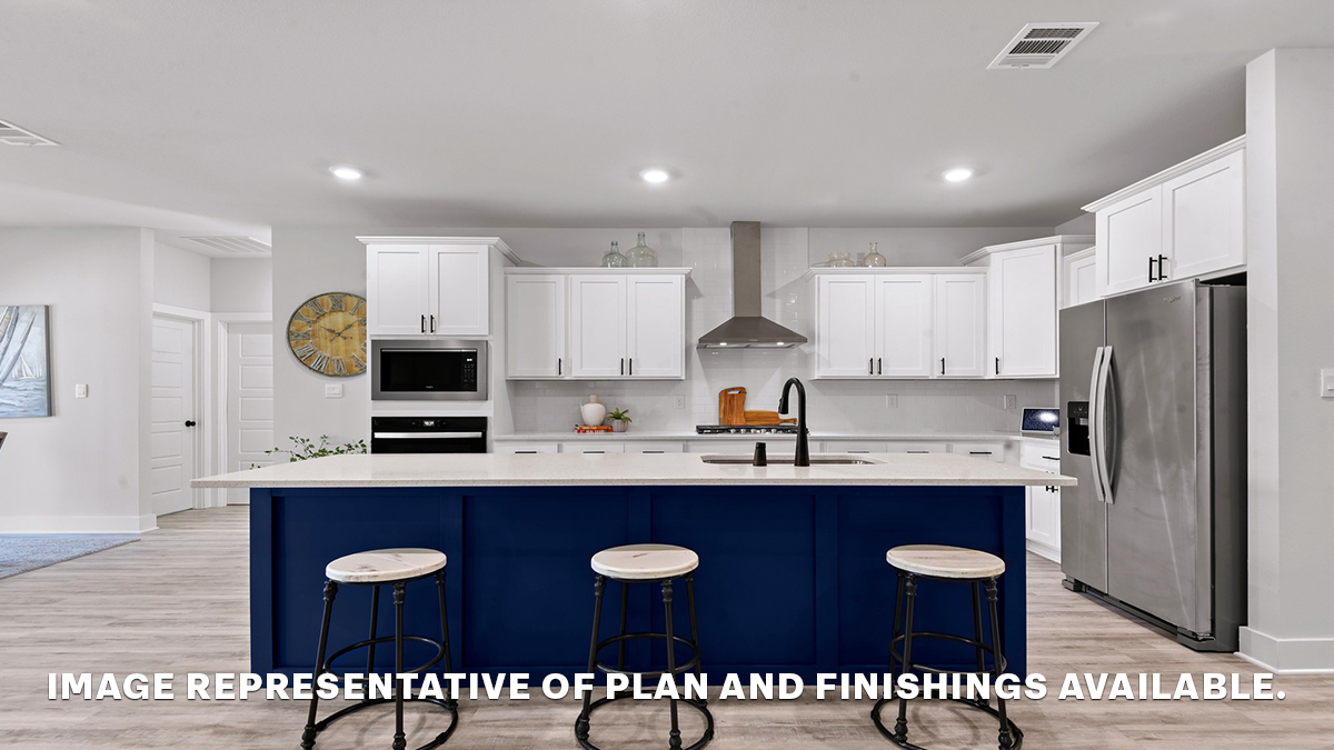 Blue kitchen island with white cabinets and stainless steel appliances and gas range and vent hood