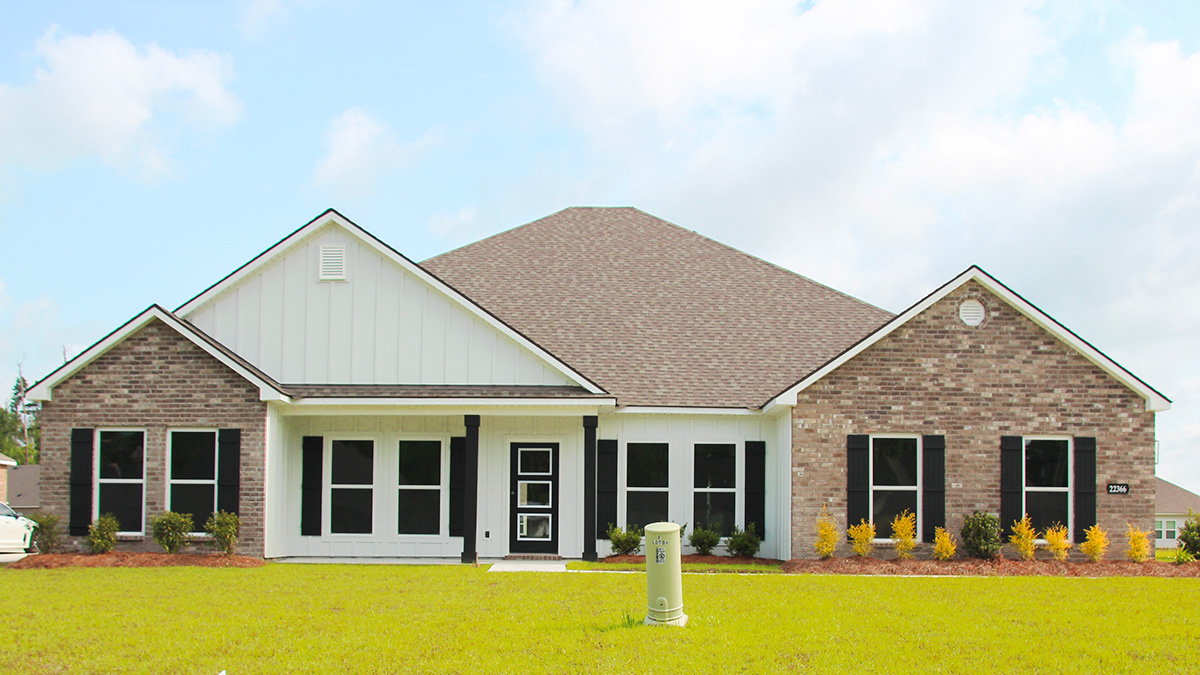 Single-story home with white hardie vinyl and brown brick. Black glass front door with black shutters and white trim.