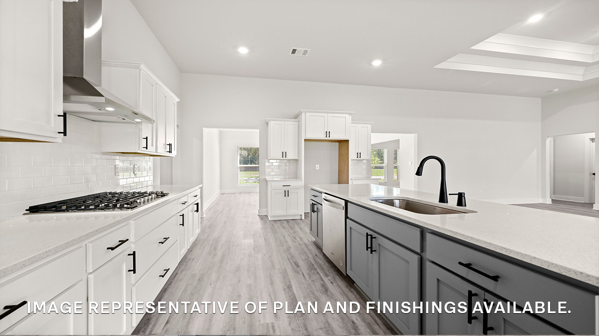 Gray kitchen island with white quartz counters and stainless steel kitchen package