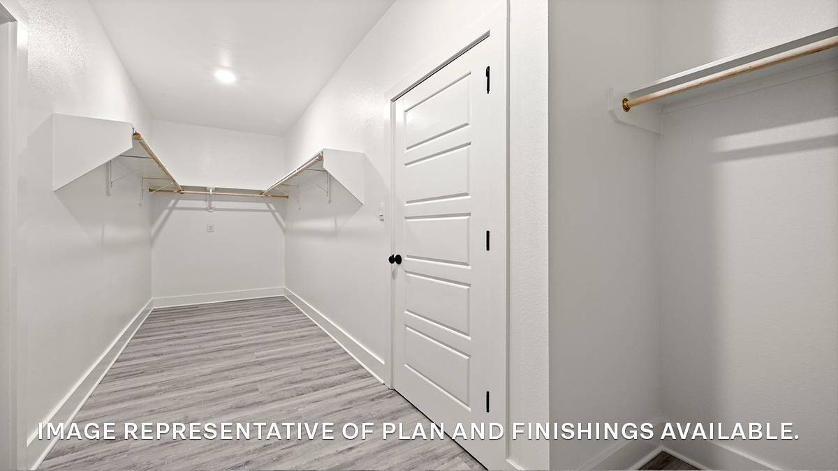 Primary bedroom walk in closet