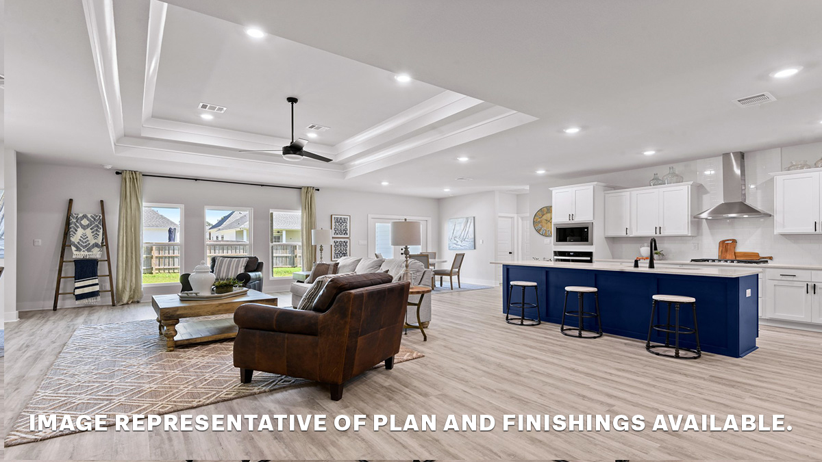 Open-concept living room and kitchen and eat in kitchen area with vaulted high ceilings and stainless steel gas appliances