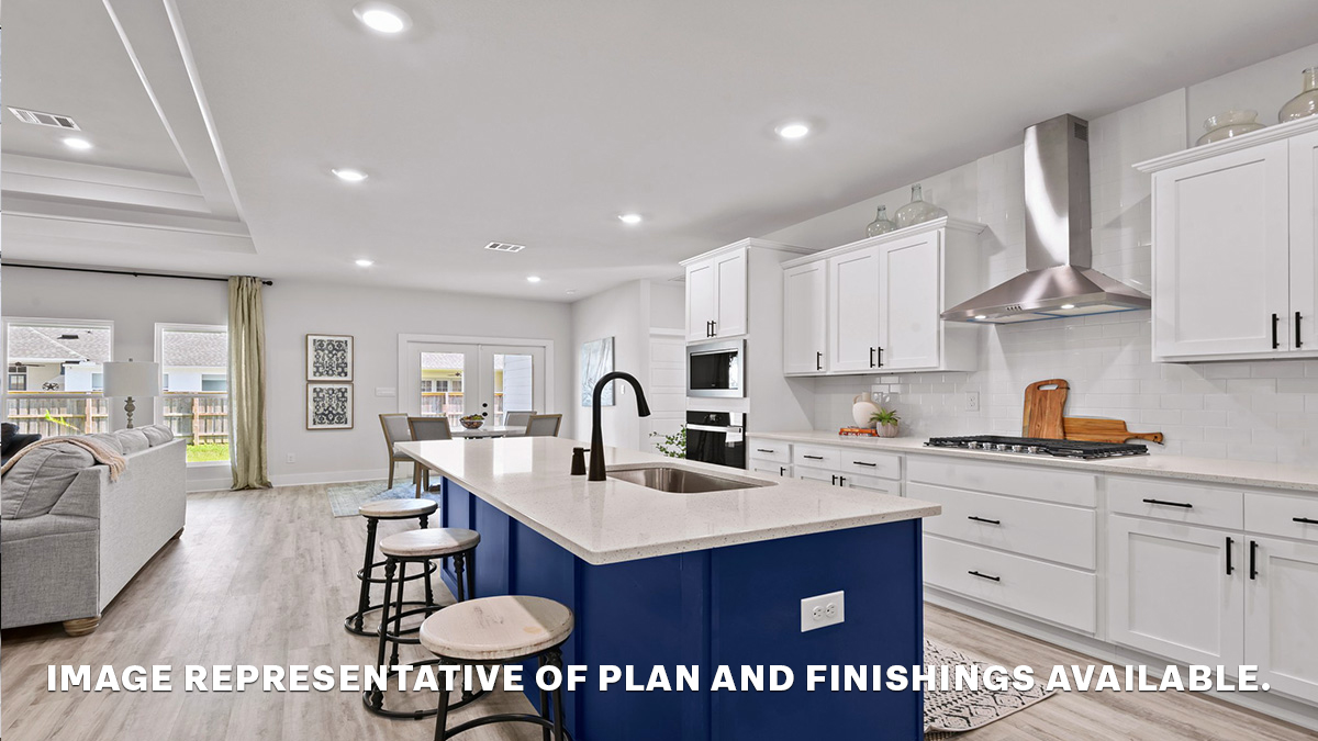 Blue kitchen island with stools and stainless steel gas appliances