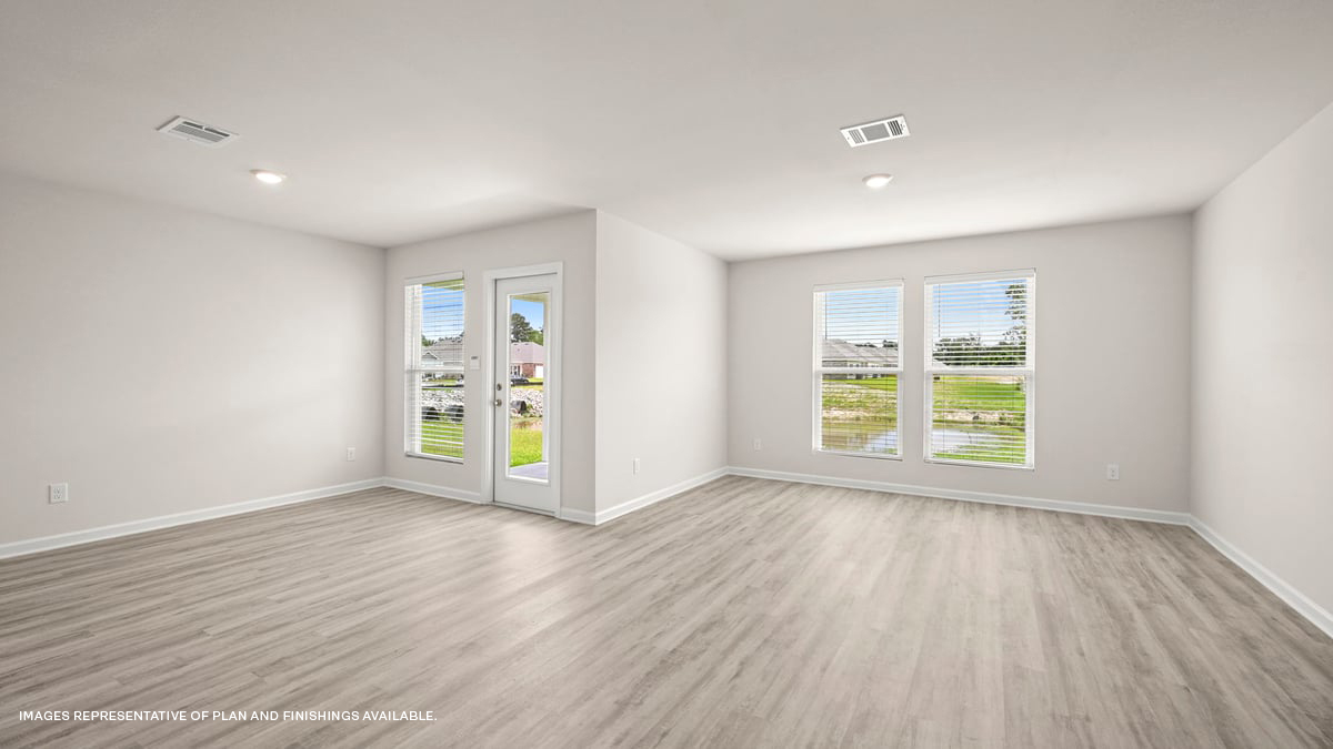 spacious living room with dual windows overlooking backyard