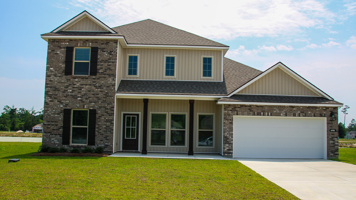 dual-story home with brown brick and brown vinyl siding with brown front door and shutters with two-car garage